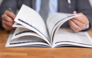 Cropped shot of an unidentifiable man reading a book